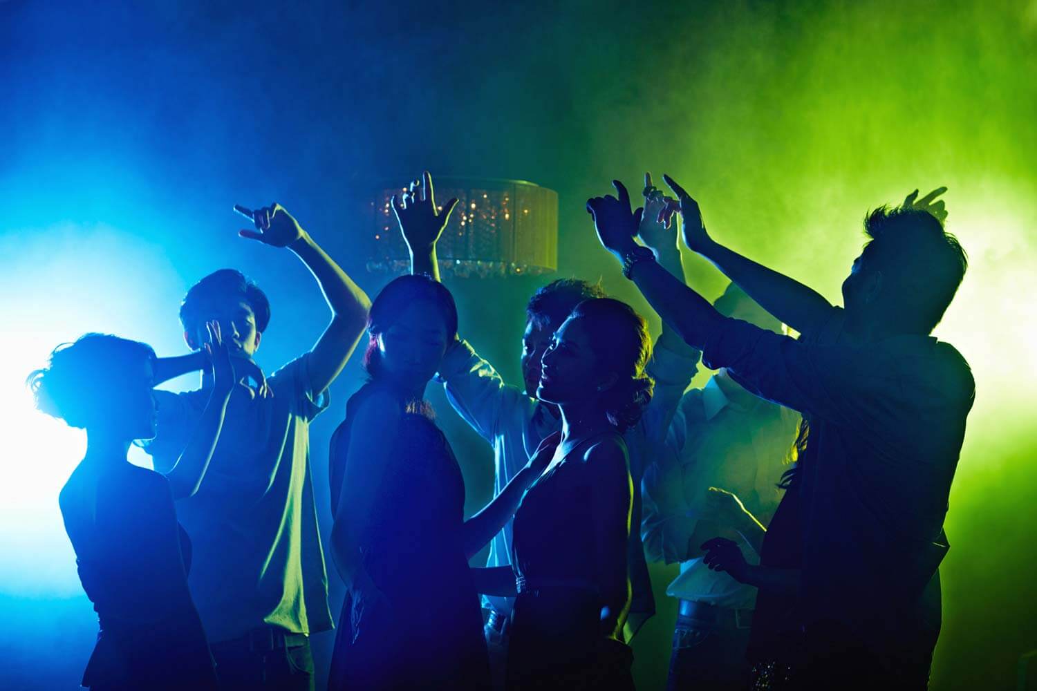depicts a group of people dancing in a club or party setting depicts a group of people dancing in a club or party setting