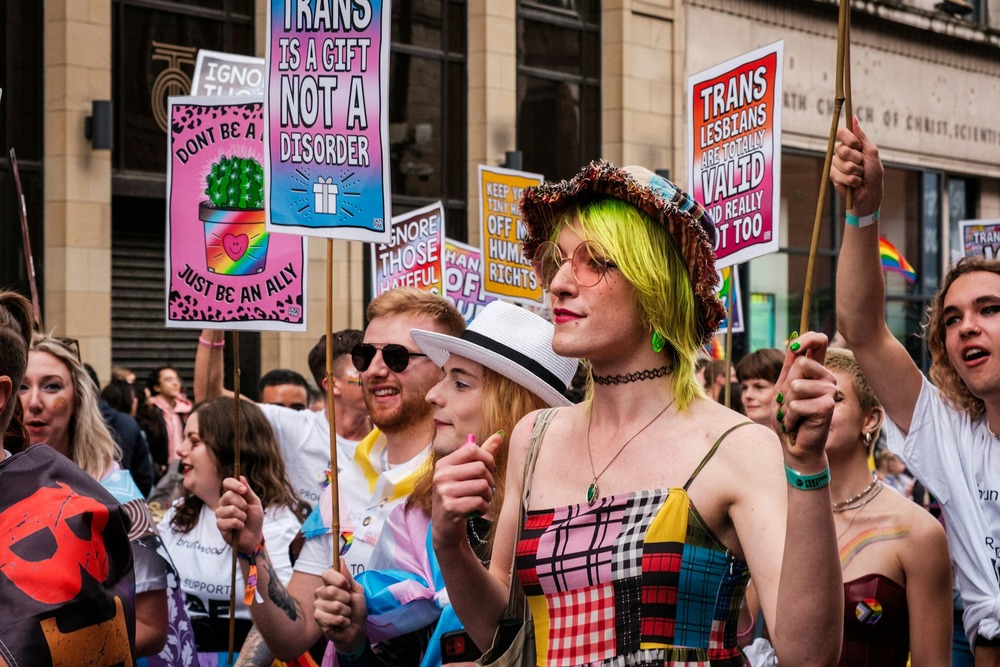 Manchester Pride People marching at Manchester Pride with placards
