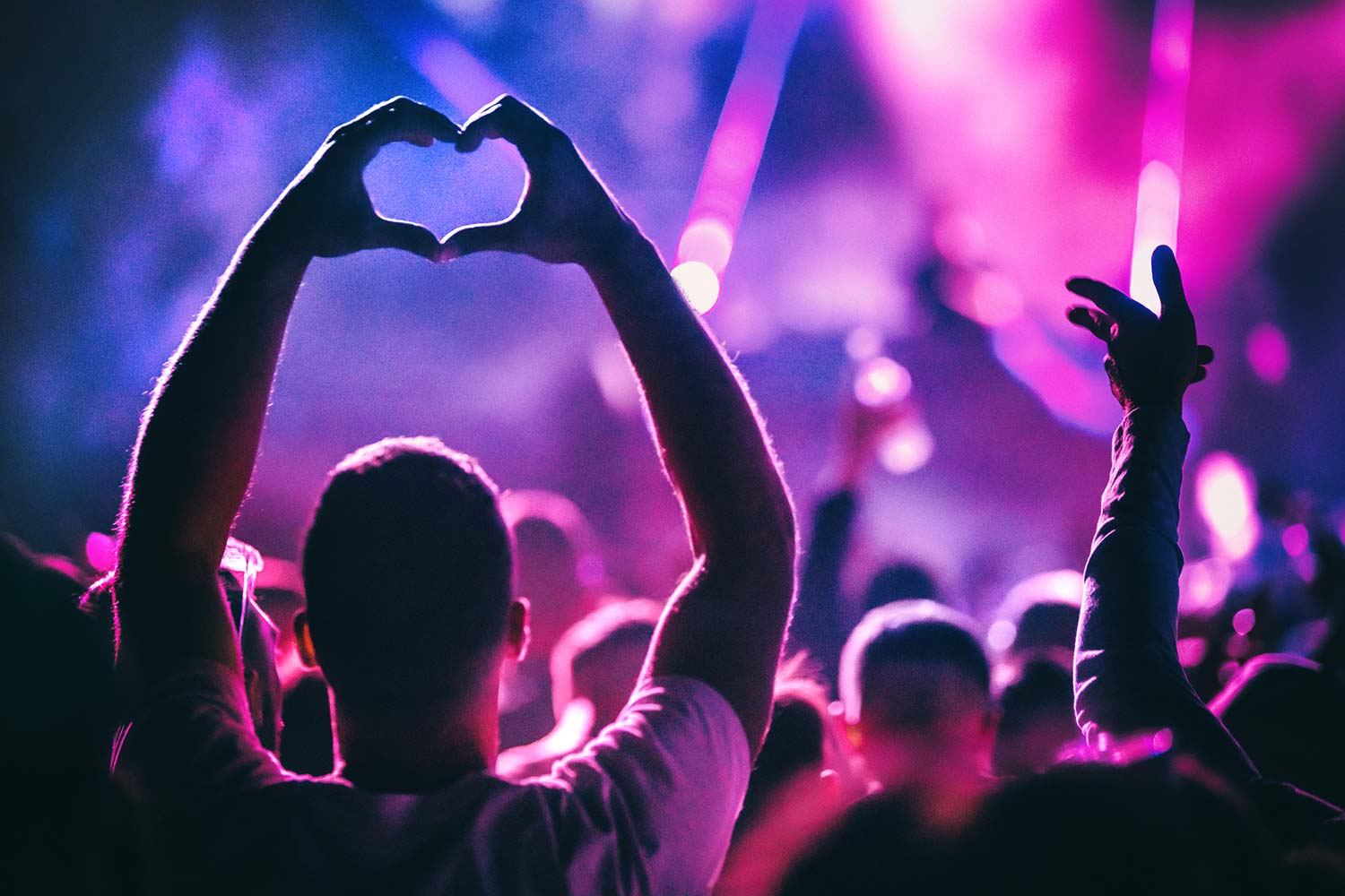 man-at-gig-making-heart-with-his-hands